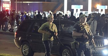 Kyle Rittenhouse (L) walks with another armed civilian, Kenosha, Wis., Aug. 25, 2020. (AP Photo)