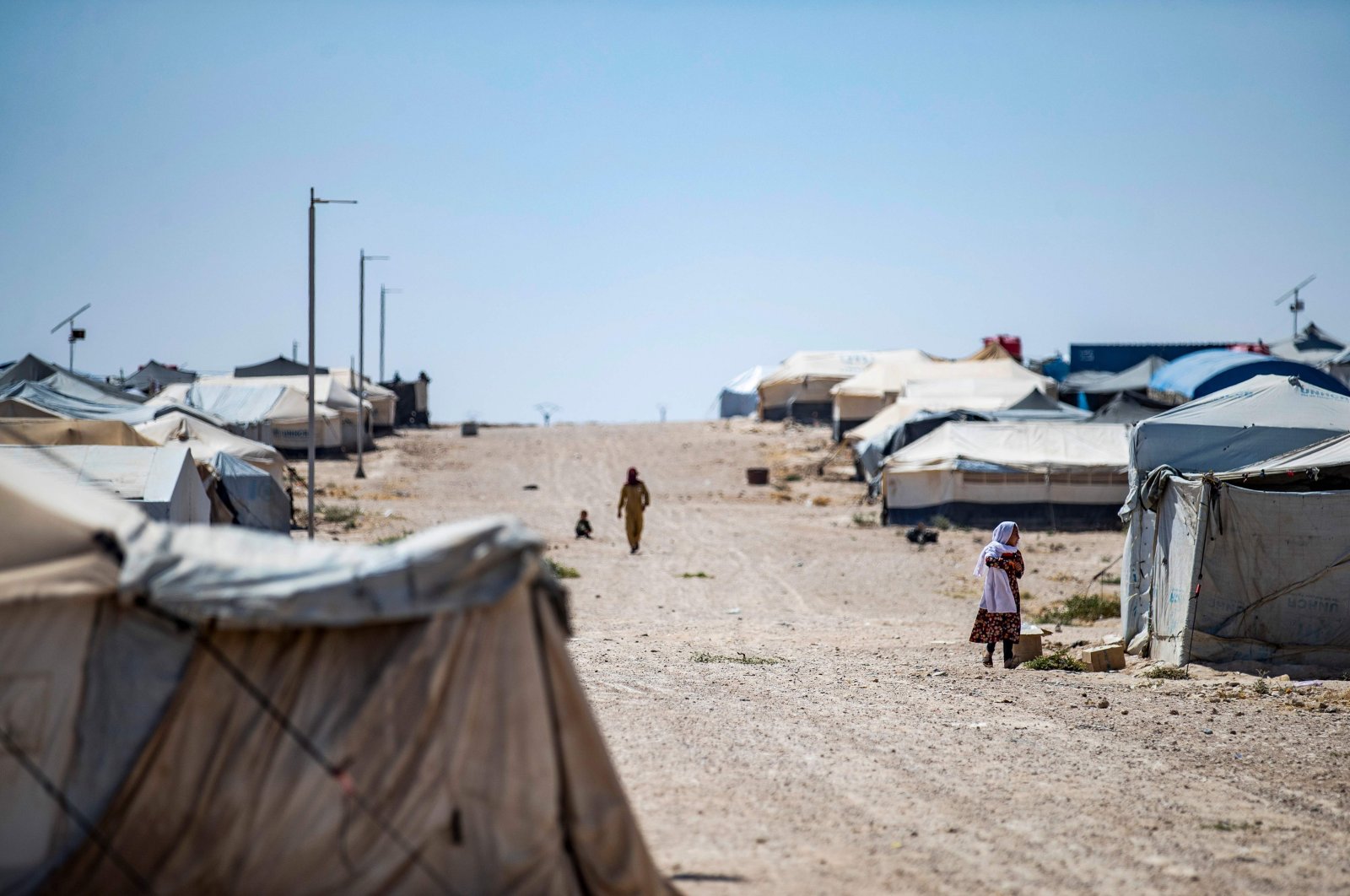 People walk past tents in the al-Hol camp in Hasakeh governorate in northeastern Syria, August 25, 2020. (AFP Photo)