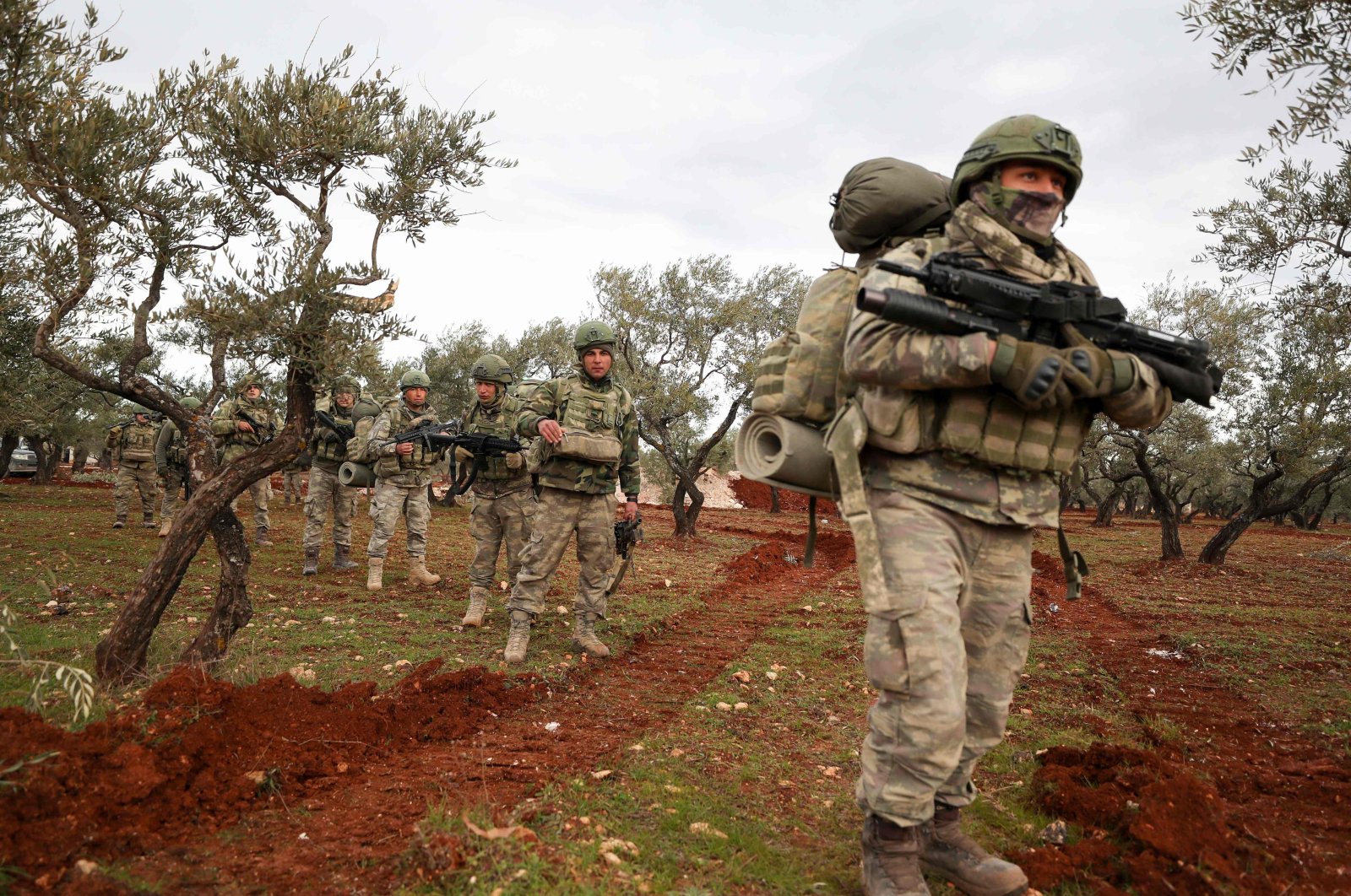 Turkish soldiers gather in the village of Qaminas, about 6 kilometers (3.7 miles) southeast of Idlib city in northwestern Syria, Feb. 10, 2020. (AFP Photo)