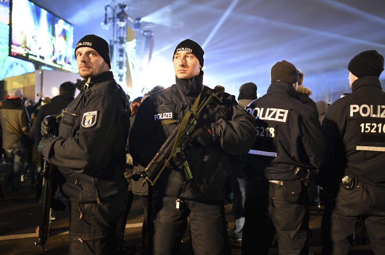 Police officers with submachine guns secure the New Year's Eve party at the Brandenburg Gate in Berlin, Saturday, Dec. 31, 2016. (AP Photo)