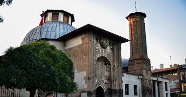 Passersby are seen in front of the İnce Minareli Madrassa, Konya, central Turkey, Aug. 28, 2020. (AA PHOTO)