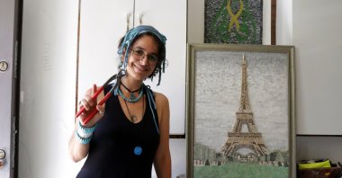 Menel Hüzmeli poses near her three-dimensional "Paris" mosaic at her workshop, Hatay, southern Turkey, Aug. 28, 2020. (AA Photo)