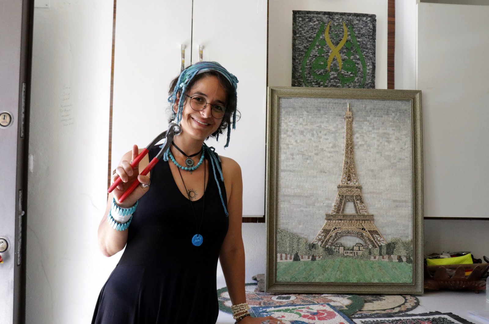 Menel Hüzmeli poses near her three-dimensional "Paris" mosaic at her workshop, Hatay, southern Turkey, Aug. 28, 2020. (AA Photo)