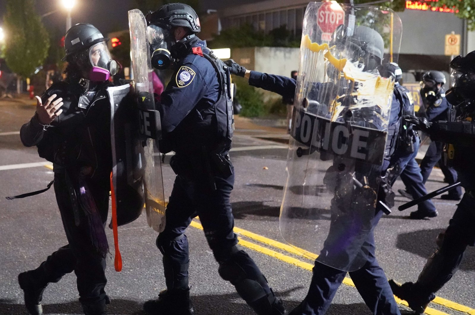 Federal officers use riot shields to push a protester while dispersing a crowd of about 150 people from in front of the Immigration and Customs Enforcement (ICE) detention facility in Portland, Oregon, U.S., Aug. 20, 2020. (AFP/Getty Images)