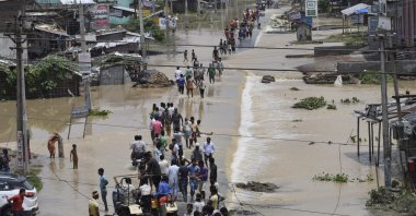 In this file photo, flood-affected villagers move to safer places at the Narpatganj Block, in Araria district, Bihar, India, Aug. 14, 2017. (AP Photo)