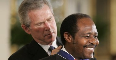 President Bush awards Paul Rusesabagina, who sheltered people at a hotel he managed during the 1994 Rwandan genocide, the Presidential Medal of Freedom Award in the East Room of the White House, in Washington D.C., Nov. 9, 2005. (AP Photo)