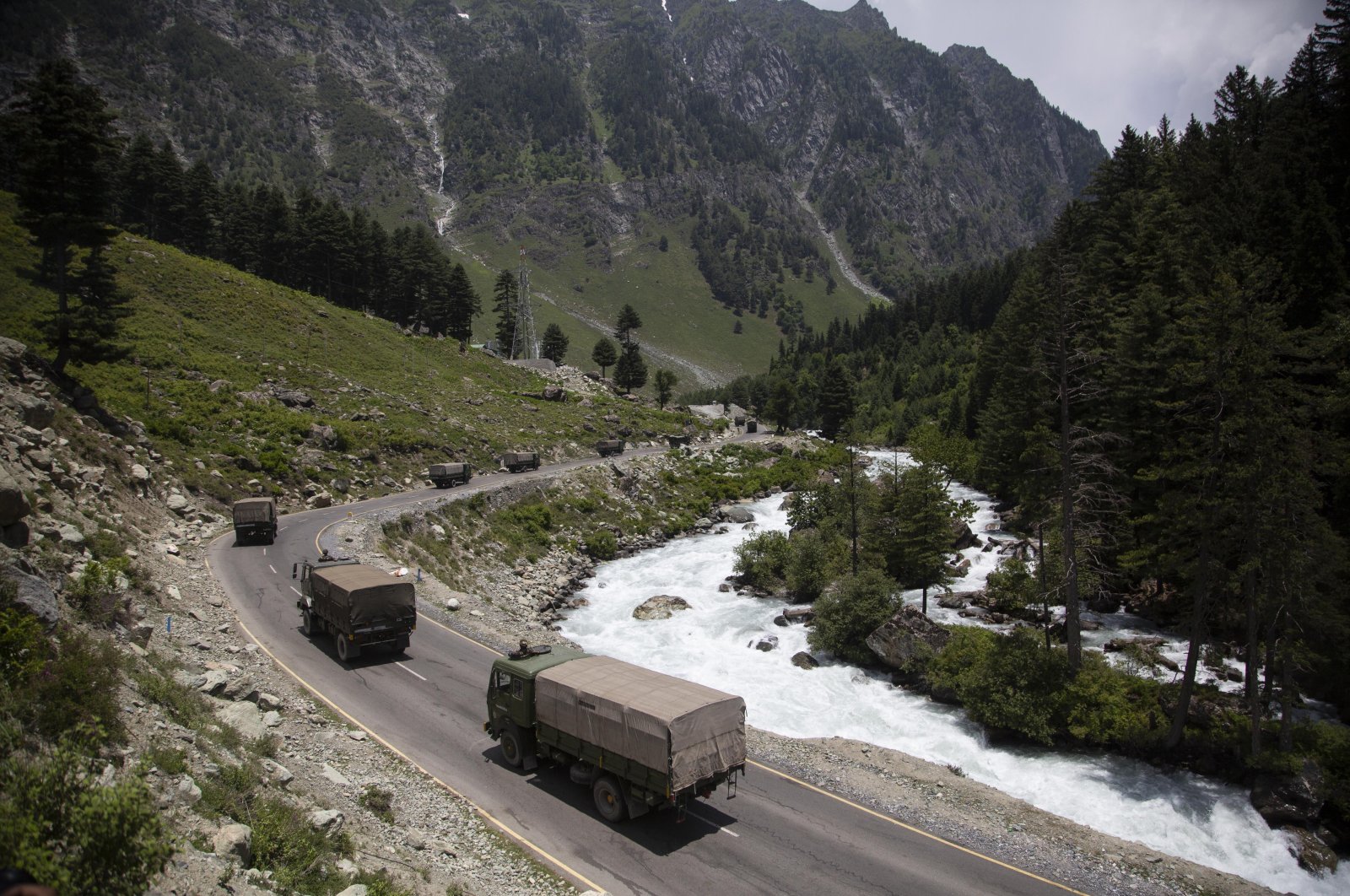In this June 17, 2020, file photo, an Indian army convoy moves on the Srinagar-Ladakh highway at Gagangeer, north-east of Srinagar, India, two days after 20 Indian soldiers died in a brawl with Chinese soldiers in the Ladakh region. (AP Photo)