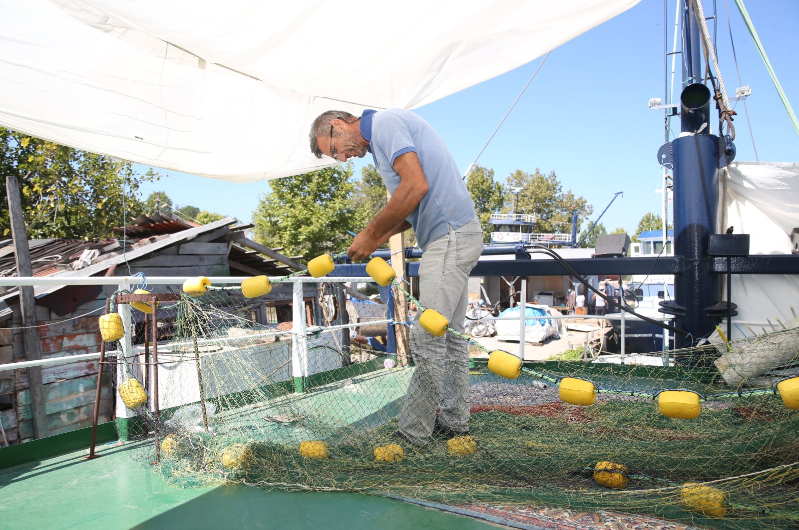 A fisherman repairs a net in Karasu district, in Sakarya, northwestern Turkey, Aug. 28, 2020. (AA Photo) 