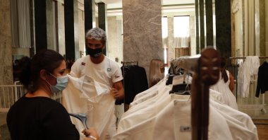 Festival workers receive their uniforms for the 77th edition of the Venice Film Festival at the Venice Lido, Italy, Aug. 31, 2020. (AP Photo)