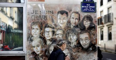 A woman walks past a painting by a French street artist in Paris, France, Aug. 31, 2020. (AFP Photo)