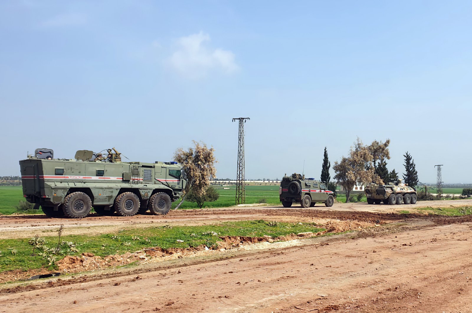 Turkish and Russian troops patrol on the M4 highway, which runs east-west through Idlib province, Syria, March 15, 2020. (Turkish Defense Ministry via AP)