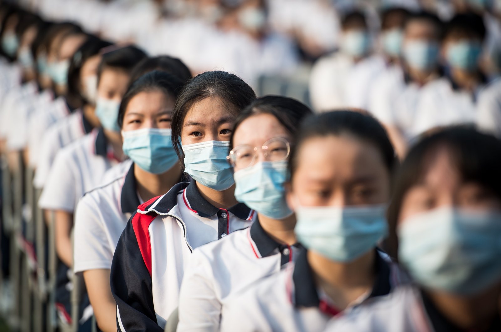 Students of Wuhan High School wearing protective face masks sit as they attend the ceremony for the new fall semester in Wuhan, Hubei Province, China, Sep. 1, 2020. (EPA Photo)