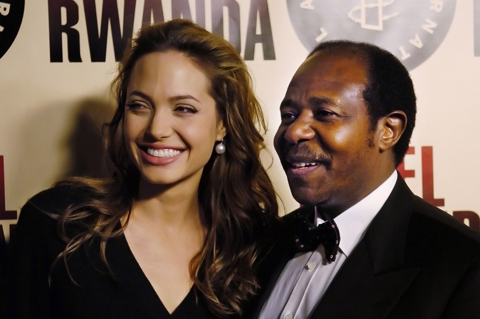 Paul Rusesabagina, the inspiration for the film "Hotel Rwanda," poses with actress Angelina Jolie at the premiere of the film at the Academy of Motion Picture Arts & Sciences in Beverly Hills, California on Dec. 2, 2004. (AP Photo)