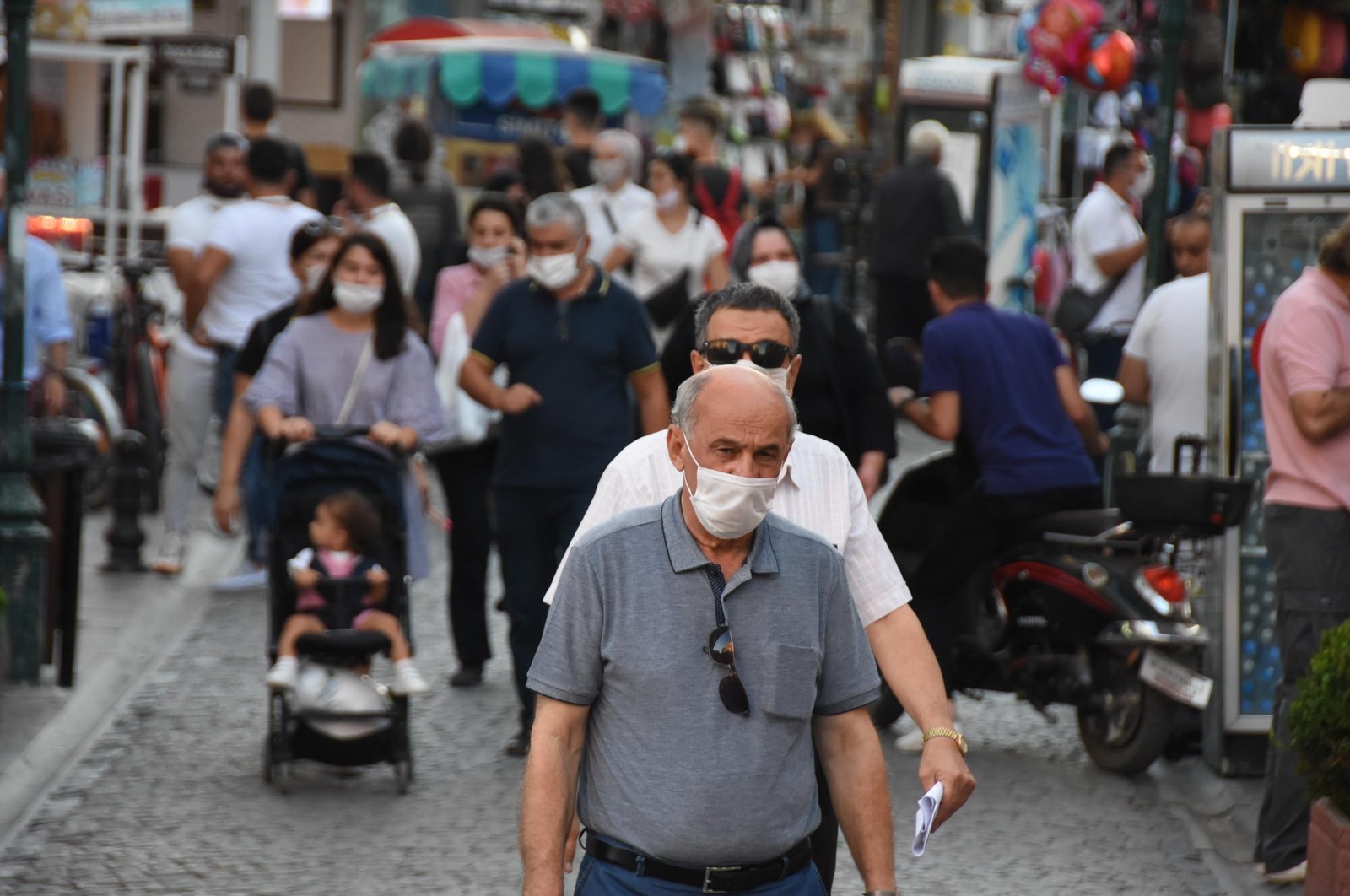People wearing protective masks walk on a street in Eskişehir, central Turkey, Sept. 1, 2020. (DHA Photo)