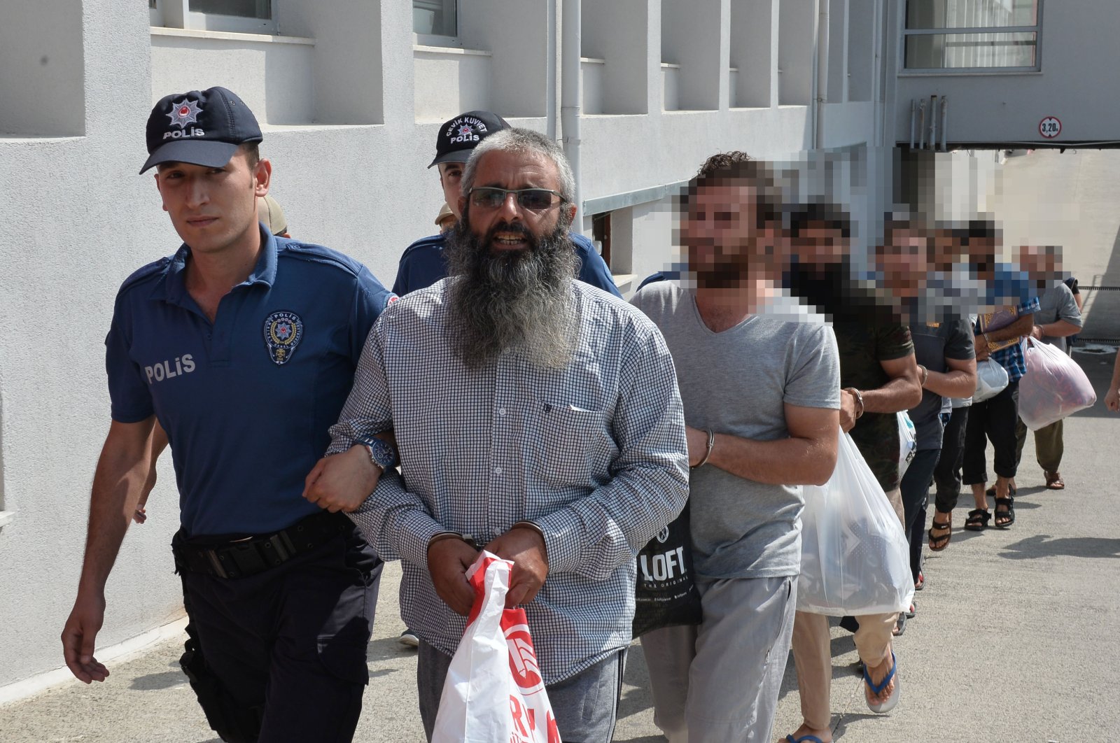 Mahmut Özden, the notorious terror suspect considered to be Daesh’s “Turkey emir,” being taken to the police station by Turkish security forces, southern Adana province, Turkey, Sept. 1, 2020. (DHA)