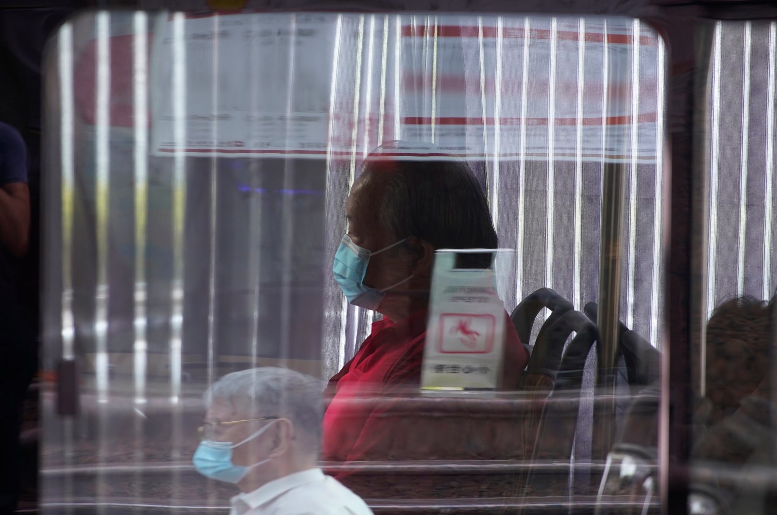 A man wearing a face mask sits on a bus amid the coronavirus disease (COVID-19) outbreak, in Shanghai, China, Aug. 27, 2020. (Reuters Photo)