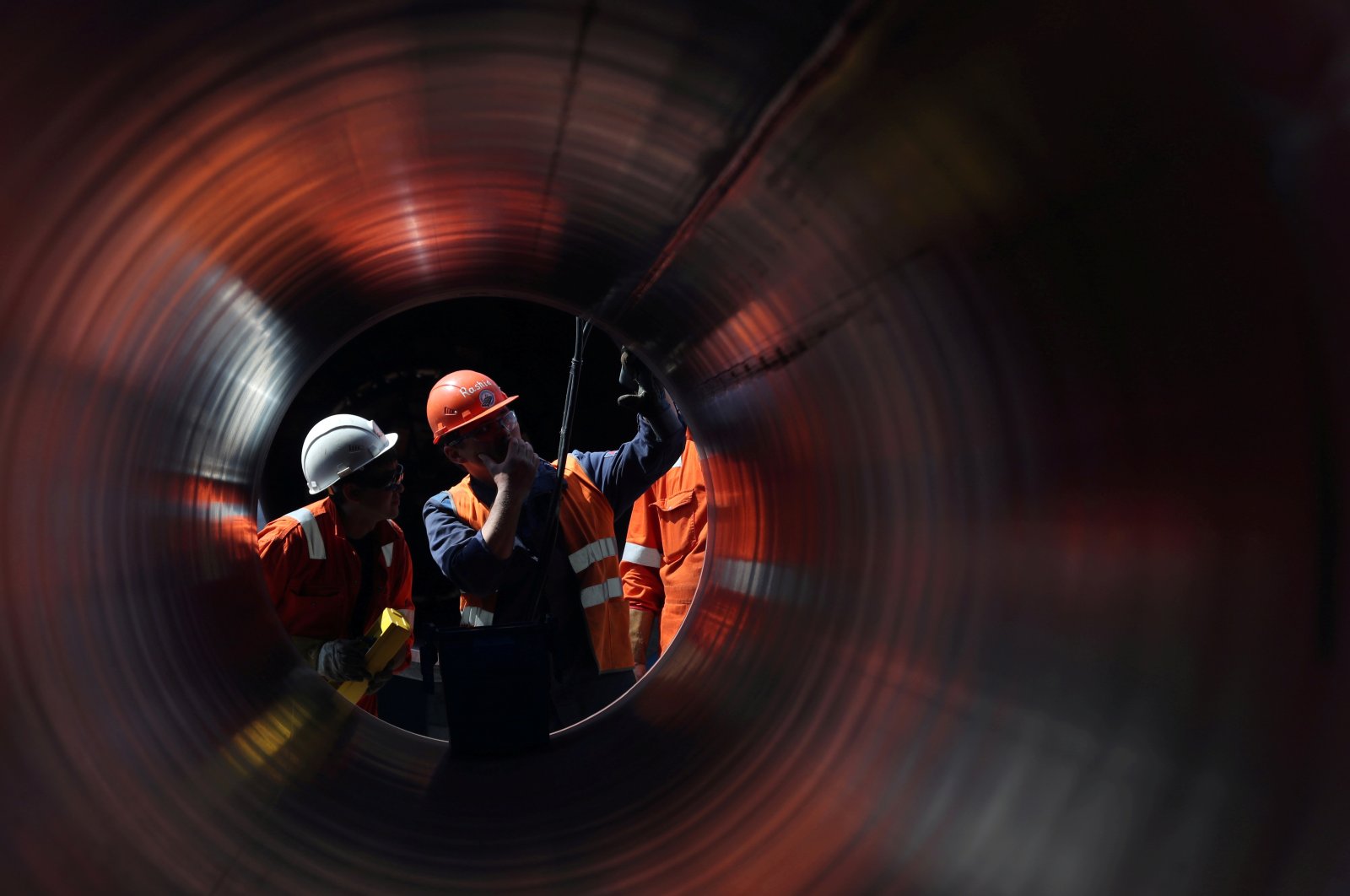 Workers are seen through a pipe at the construction site of the Nord Stream 2 gas pipeline, near the town of Kingisepp, Leningrad region, Russia, June 5, 2019. (Reuters Photo)
