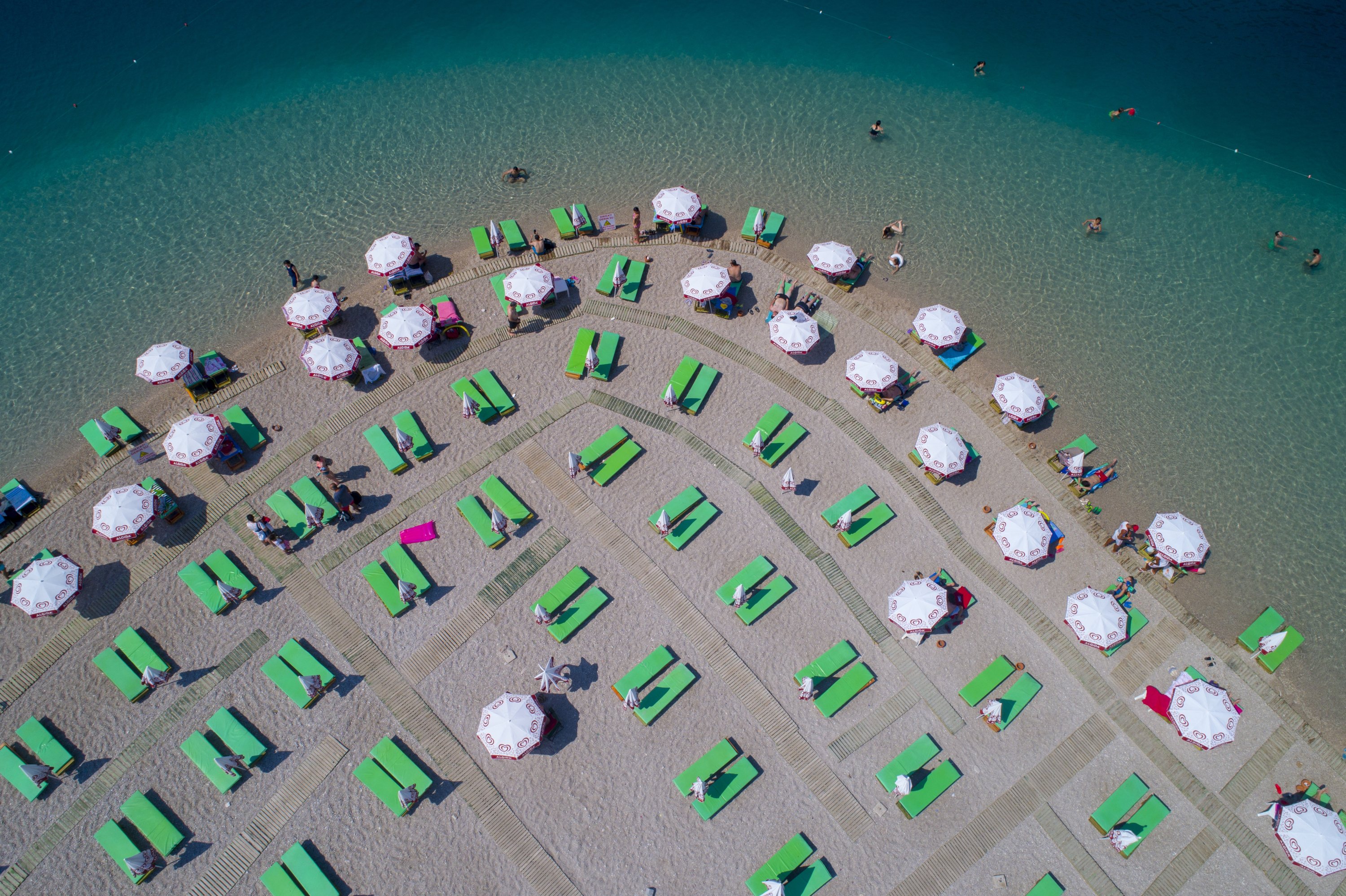 Sunbeds and umbrellas have been placed at least 1.5 meters apart at Ölüdeniz Beach in Fethiye, Muğla province, Turkey. (AA Photo)