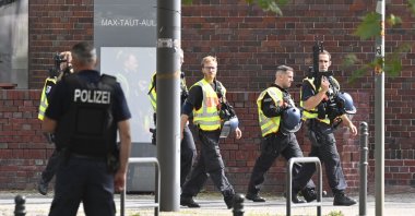 German armed policemen walk past a school in Berlin's Rummelsburg district, Germany, Aug. 28, 2020. (AFP Photo)