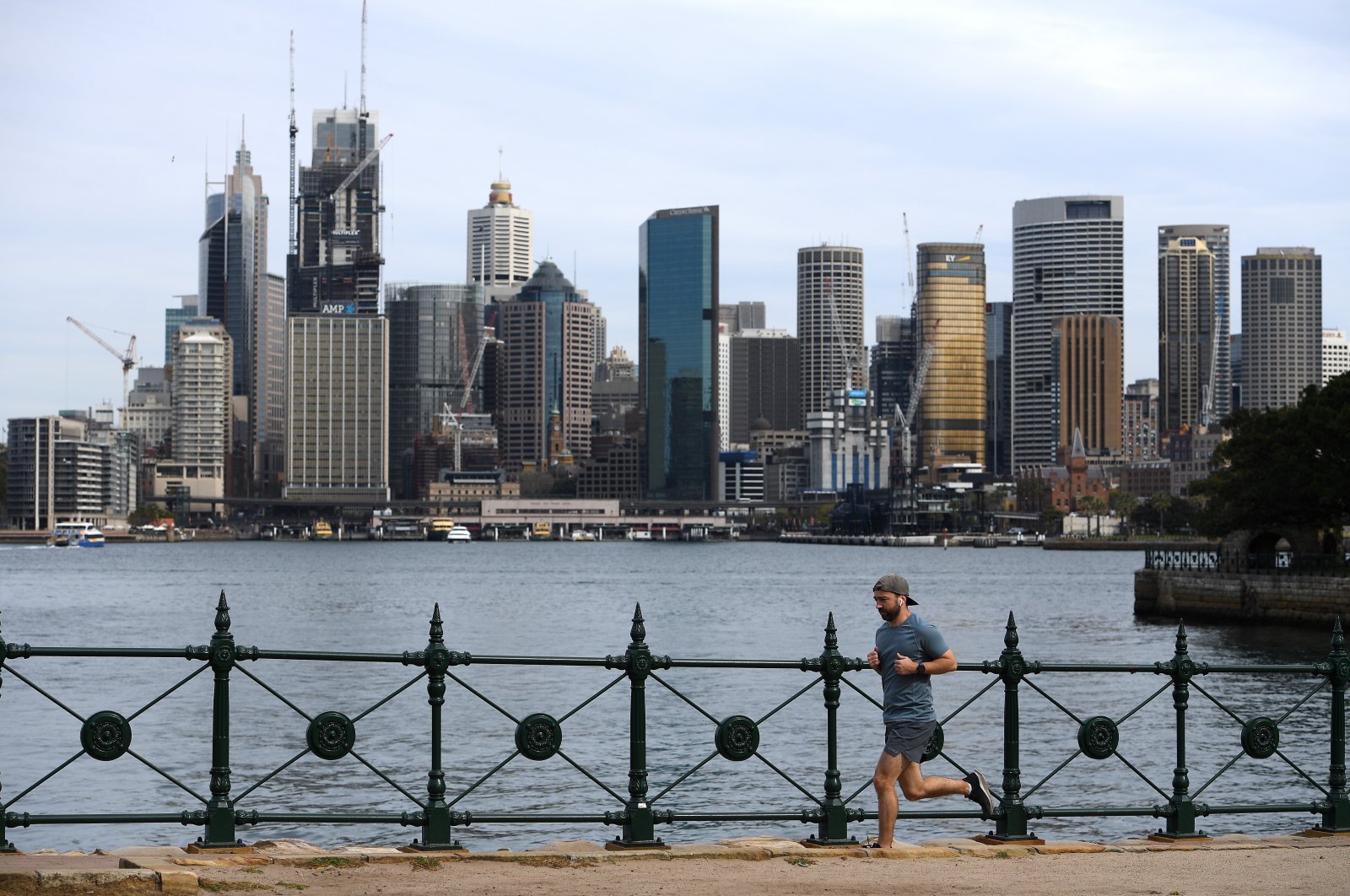 A man jogs in view of the city skyline in Sydney, Australia, Sept. 02, 2020. (EPA Photo)