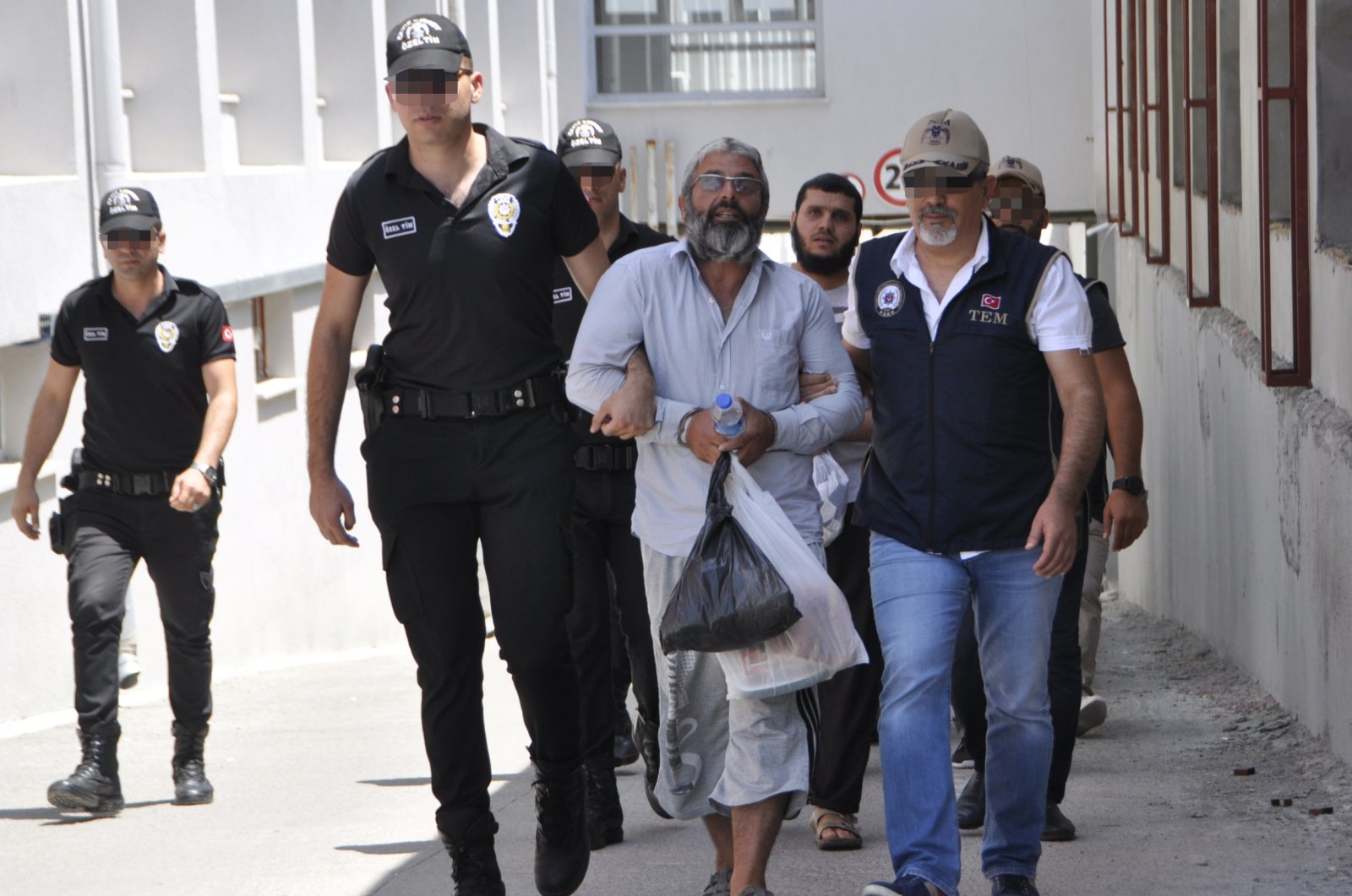 Mahmut Özden, the leader of the Daesh terrorist group in Turkey, is escorted by police in this undated photo. (AA Photo)