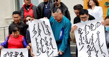 Demonstrators, holding signs with Mongolian script, protest against China's changes to school curriculums that remove Mongolian language from core subjects, outside the Mongolian Ministry of Foreign Affairs in Ulaanbaatar, Mongolia, Aug. 31, 2020. (Reuters Photo)