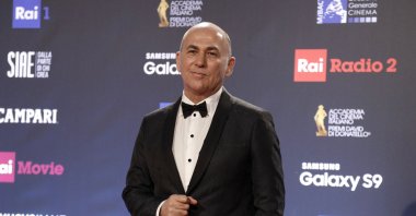 Turkish director Ferzan Özpetek walks the red carpet as he arrives to attend the David Donatello awards ceremony in Rome, March 21, 2018. (AP Photo)