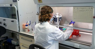 A scientist works at a manufacturing laboratory where a vaccine against the coronavirus disease (COVID-19) has been produced at the Oxford Vaccine Group's facility at the Churchill Hospital in Oxford, England, June 24, 2020. (Reuters Photo)