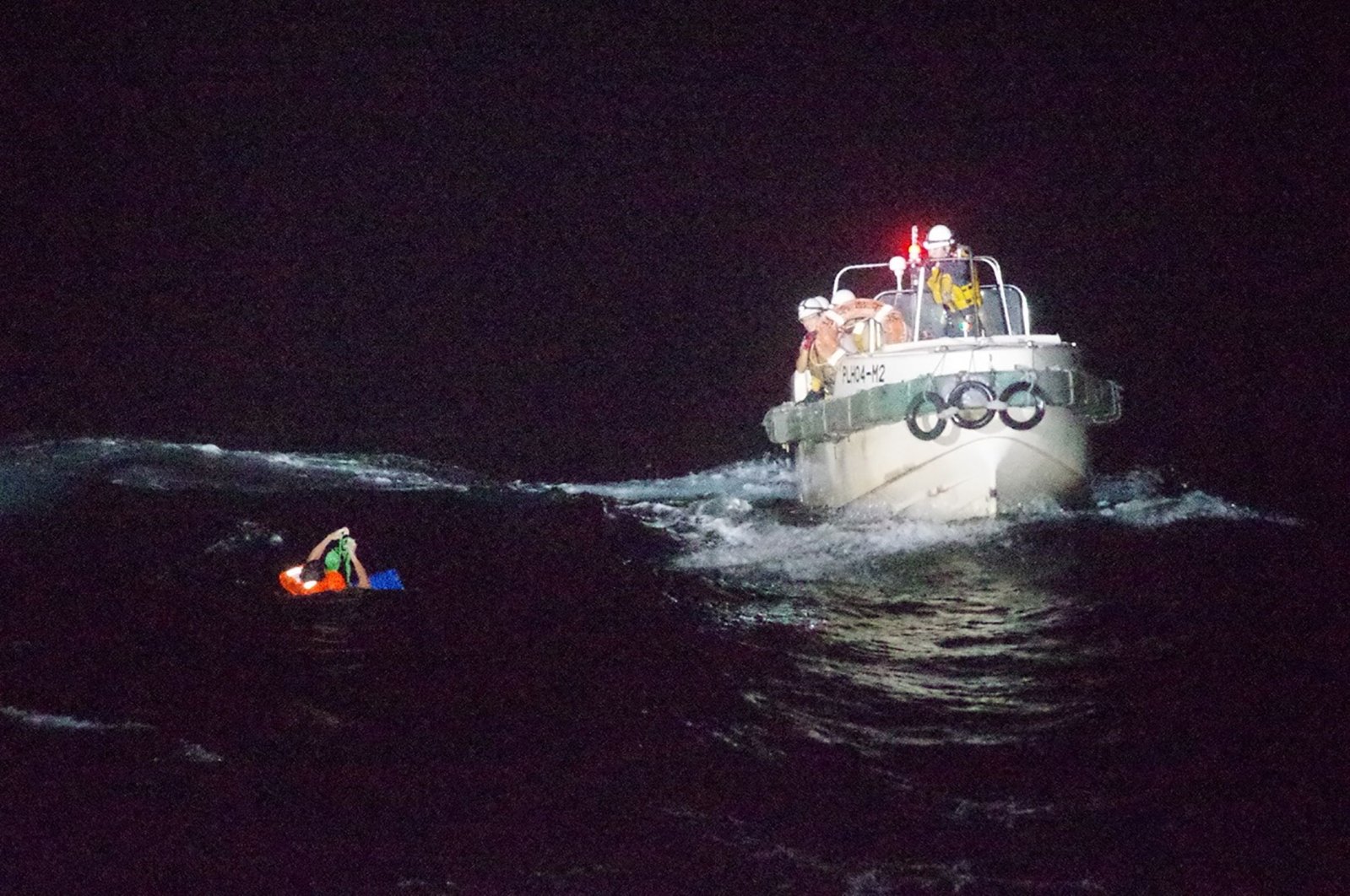 Coast guards rescuing a Filipino man off Amami Oshima island, about 120 kilometers northwest of the sea, Sept. 2, 2020. (AFP Photo / 10th Regional Coast Guard Headquarters)