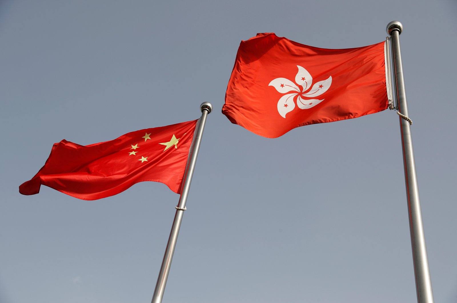 The Chinese and Hong Kong flags flutter at the office of the Government of the Hong Kong Special Administrative Region, ahead of a news conference held by Hong Kong Chief Executive Carrie Lam, in Beijing, China June 3, 2020. (Reuters Photo)