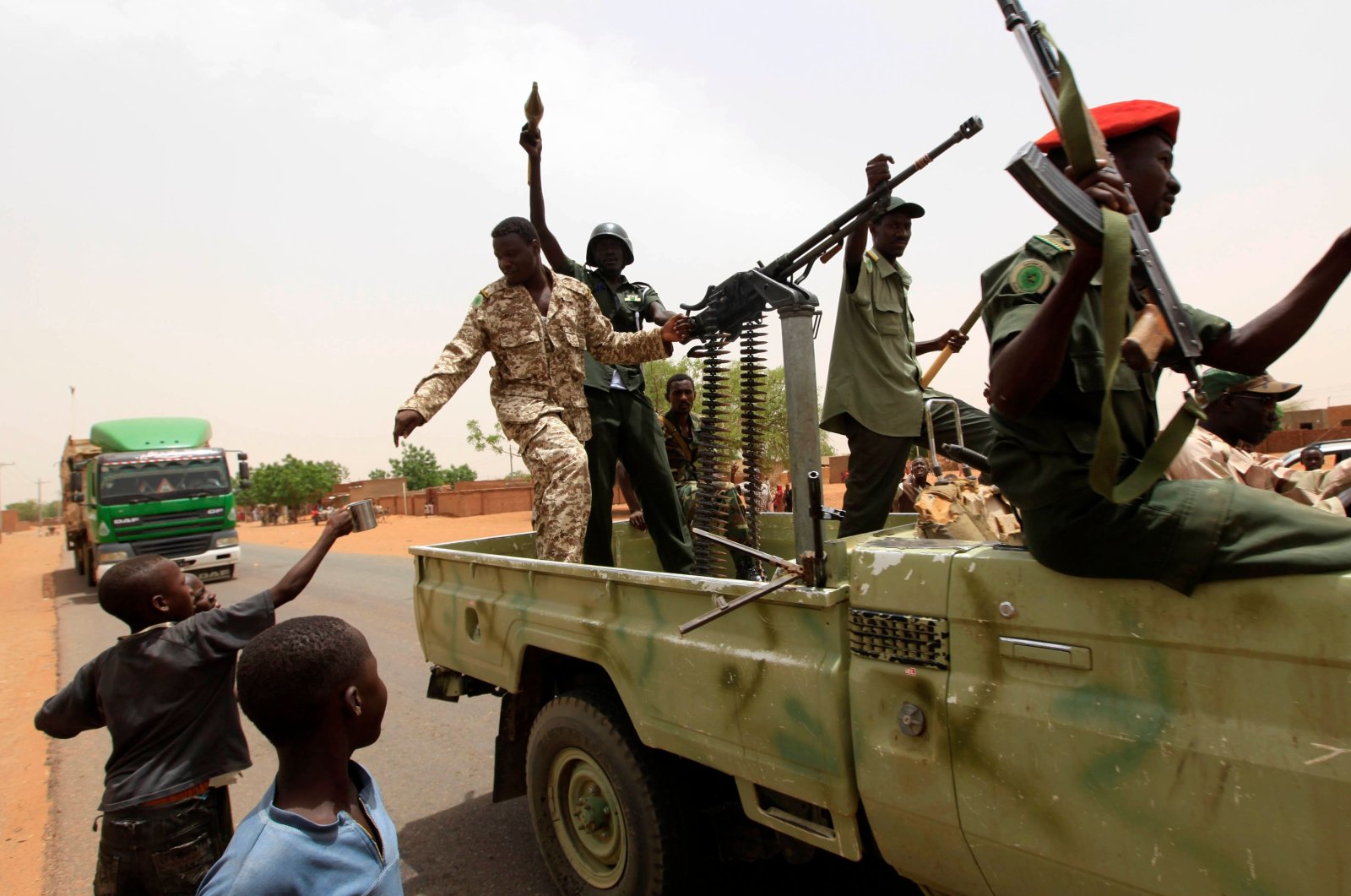 In this file photo, Sudanese forces celebrate after reportedly regaining control of the district of Abu Kershola, a town in which rebels of the Sudan Revolutionary Front coalition seized on April 27, in South Kordofan on May 28, 2013. (AFP Photo)