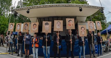 Protesters hold up signs with pictures of the victims of Neo-Nazi cell National Socialist Underground (NSU) before the proclamation of sentence in the trial against Beate Zschaepe, the only surviving member of the NSU behind a string of racist murders, in Munich, July 11, 2018. (AFP Photo)
