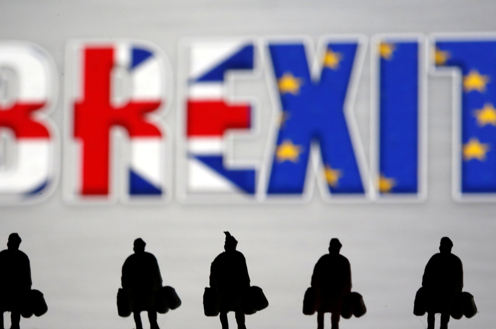 Small toy figures are seen in front of a Brexit logo in this illustration picture, March 30, 2019. (Reuters Photo)
