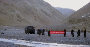 In this May 5, 2013, file photo, Chinese troop hold a banner which reads: "You've crossed the border, please go back," in Ladakh, India. (AP Photo)