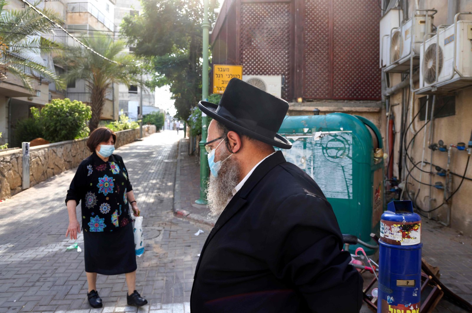Ultra-Orthodox Jews wearing protective face masks walk in the ultra-Orthodox city of Bnei Brak, near Tel Aviv, on Sept. 6, 2020. (AFP Photo)