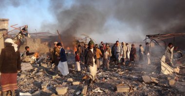 In this file photo taken on Jan. 6, 2018 smoke rises as Yemenis inspect the damage at the site of airstrikes in the northwestern Huthi-held city of Saada. (AFP Photo)