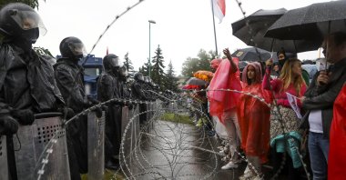 Protesters argue with police standing in front of a police barricade, Minsk, Sept. 6, 2020. (AP Photo)