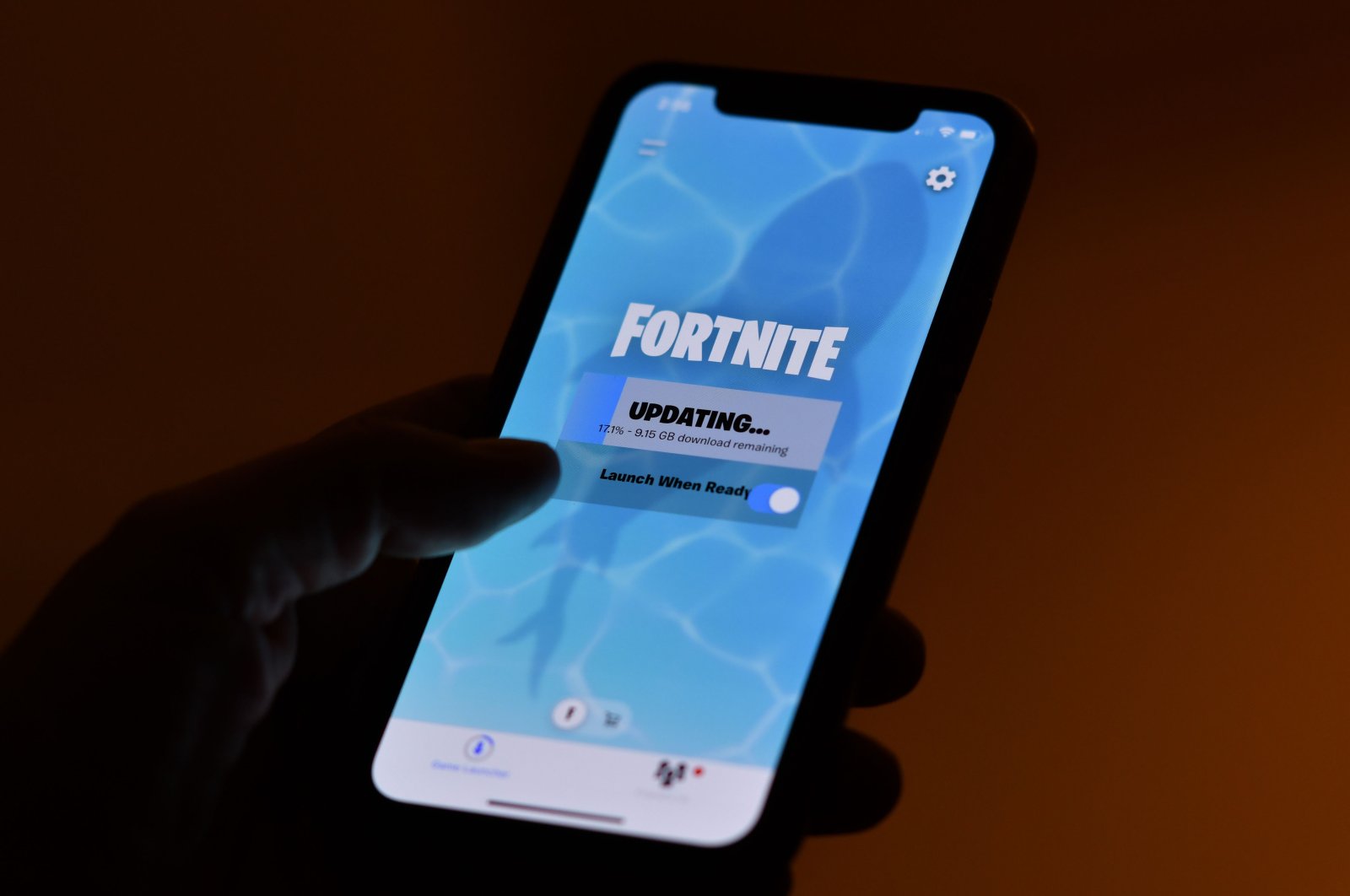 This illustration picture shows a person waiting for an update of Epic Games' Fortnite on their smartphone in Los Angeles on Aug. 14, 2020. (AFP Photo)