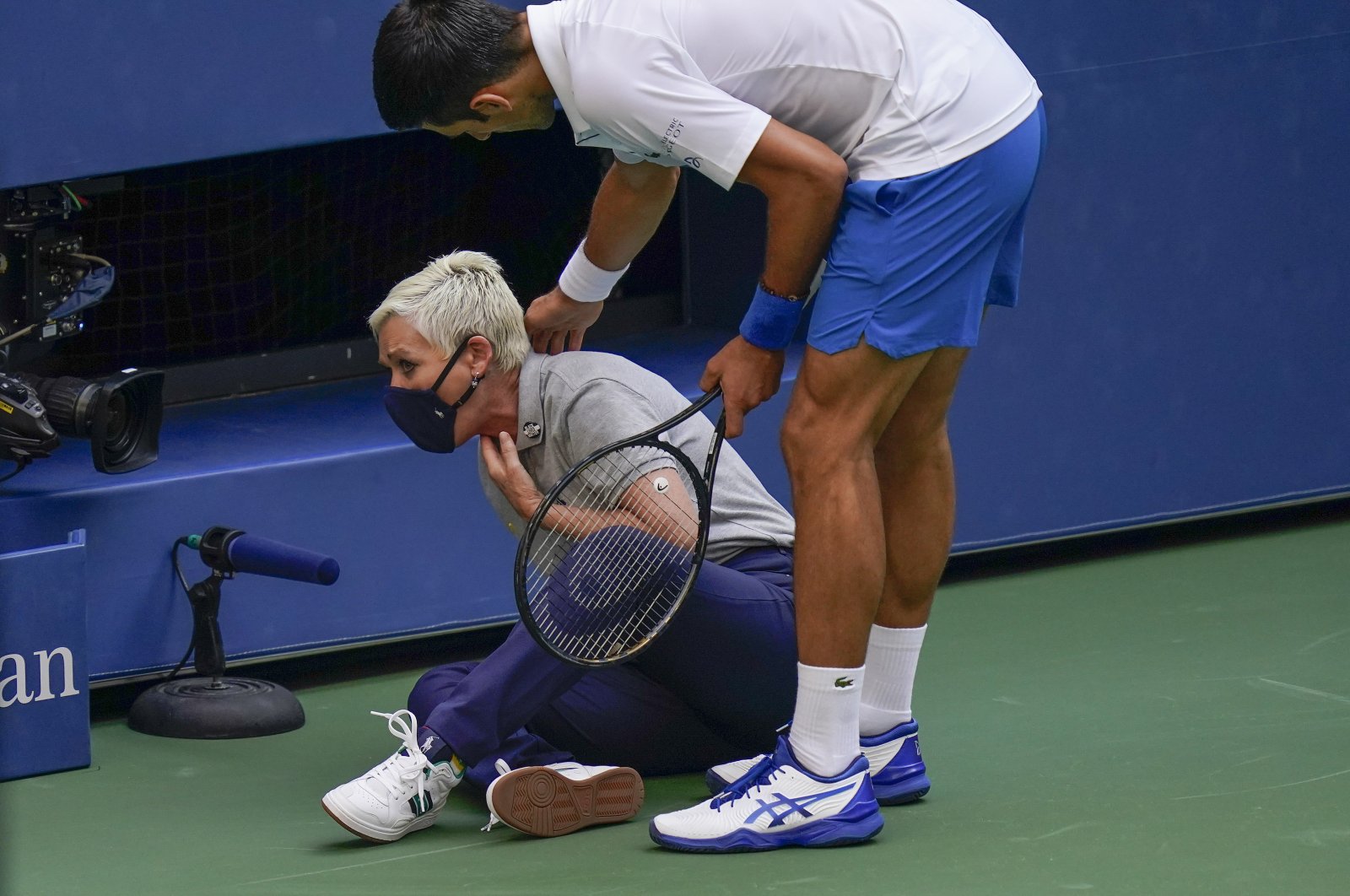 Novak Djokovic checks a linesman after hitting her with a ball in reaction to losing a point during the fourth round of the U.S Open, in New York, U.S., Sept. 6, 2020. (AP Photo)