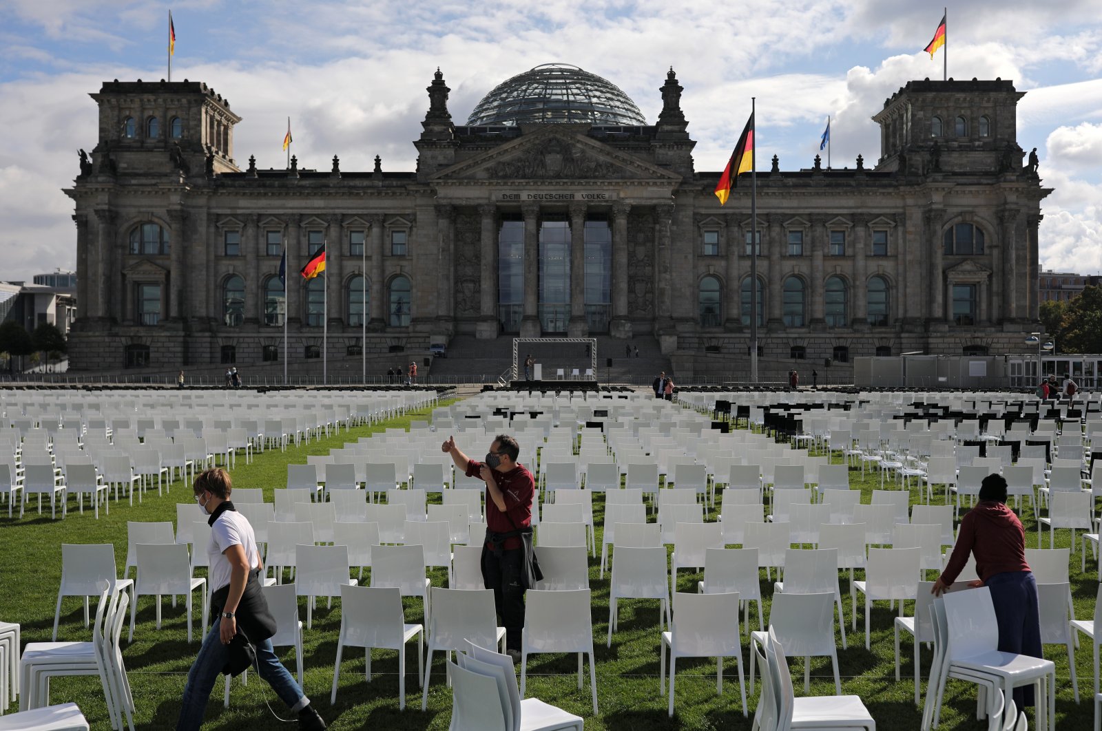 Activists set up empty chairs for a protest demanding the evacuation of Greek migrant camps, in front of the Reichstag building in Berlin, Germany, September 7, 2020. (Reuters Photo)
