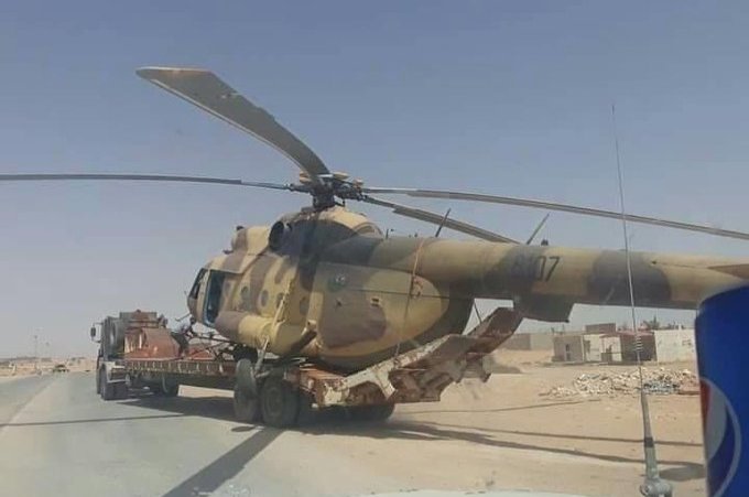 GNA forces carry the helicopter away from the spot where it landed in Libya's Abu Grein area, Sept. 7, 2020. (Photo from Facebook)