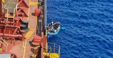 Migrants sit in a boat alongside the Maersk Etienne tanker off the coast of Malta, Aug. 19, 2020. (Reuters Photo)