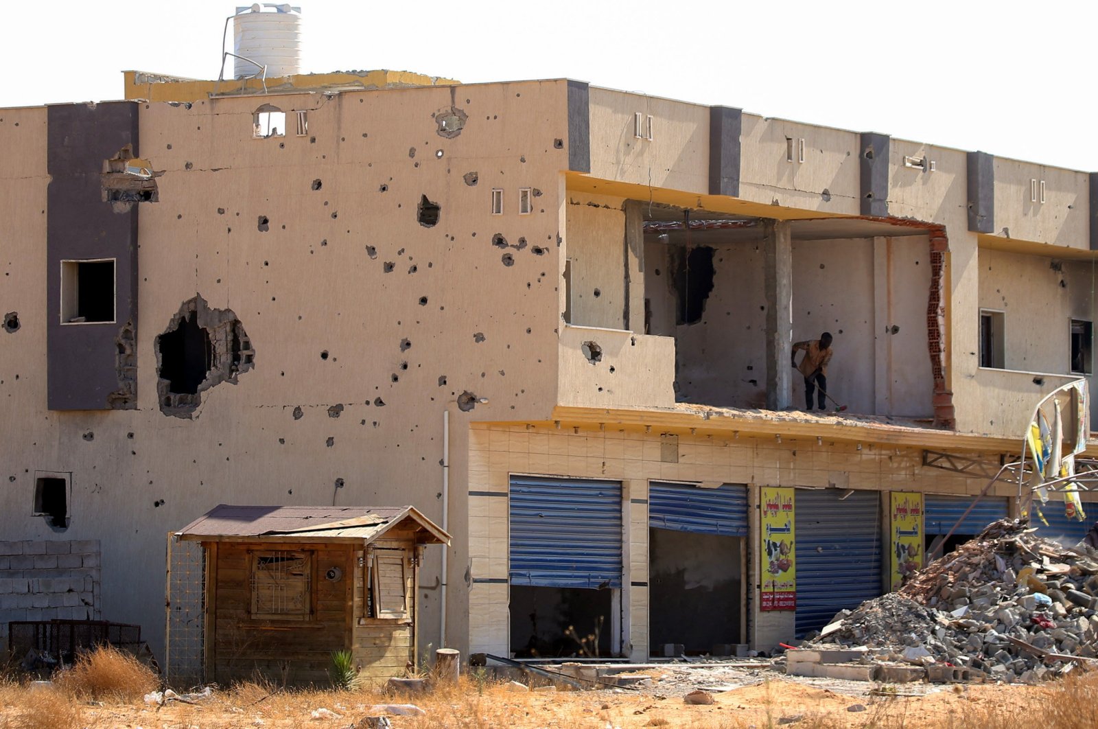 A picture shows a business, damaged during the 14 months of fighting between the U.N. recognized Government of National Union (GNA) and putschist Gen. Khalifa Haftar, in a southern neighborhood in the capital Tripoli on July 9, 2020. (AFP File Photo)