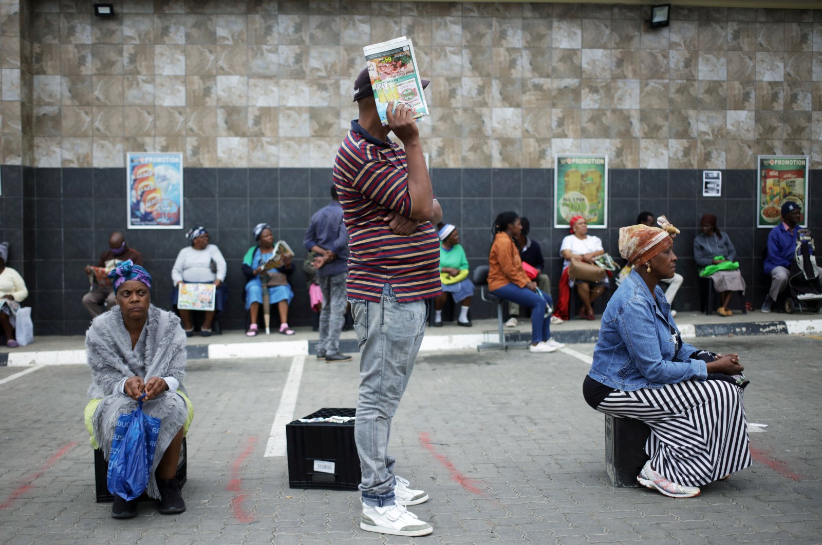 Shoppers queue in line with social distance rules during a 21-day nationwide COVID-19 lockdown in Soweto, South Africa, March 30, 2020. (Reuters Photo)