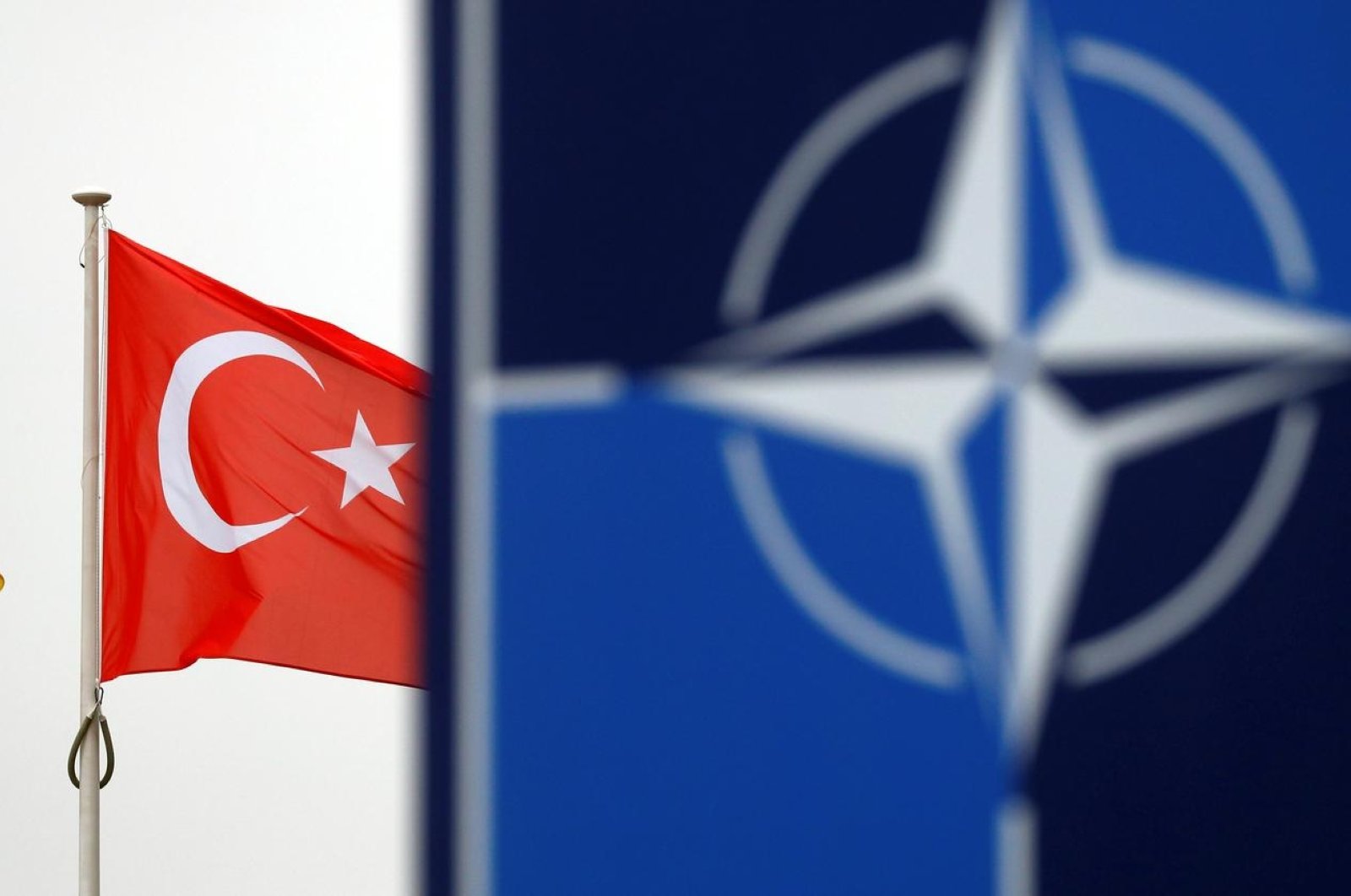 A Turkish flag flies next to the NATO logo at the alliance's headquarters in Belgium’s Brussels, Nov. 26, 2019. (Reuters Photo)