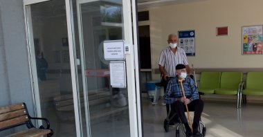Kurteş Sap (standing) and his dad Şaban Sap leave the hospital after testing negative for COVID-19, in Tokat province's Niksar district, northern Turkey, Sept. 8, 2020. (AA Photo)