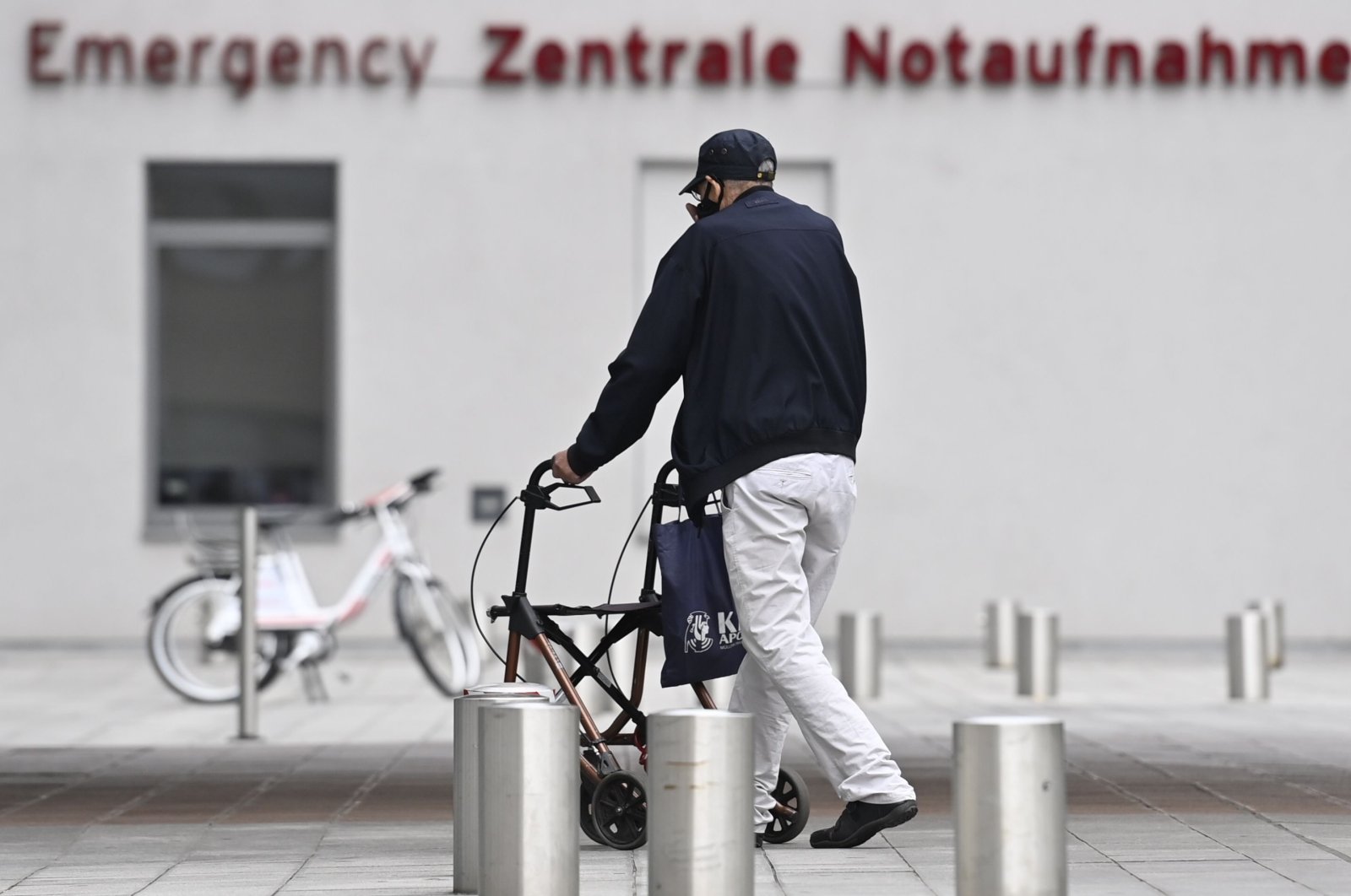 A man using a walker passes the emergency department of the Charite hospital in Berlin's Mitte district on Sept. 8, 2020. (AFP Photo)