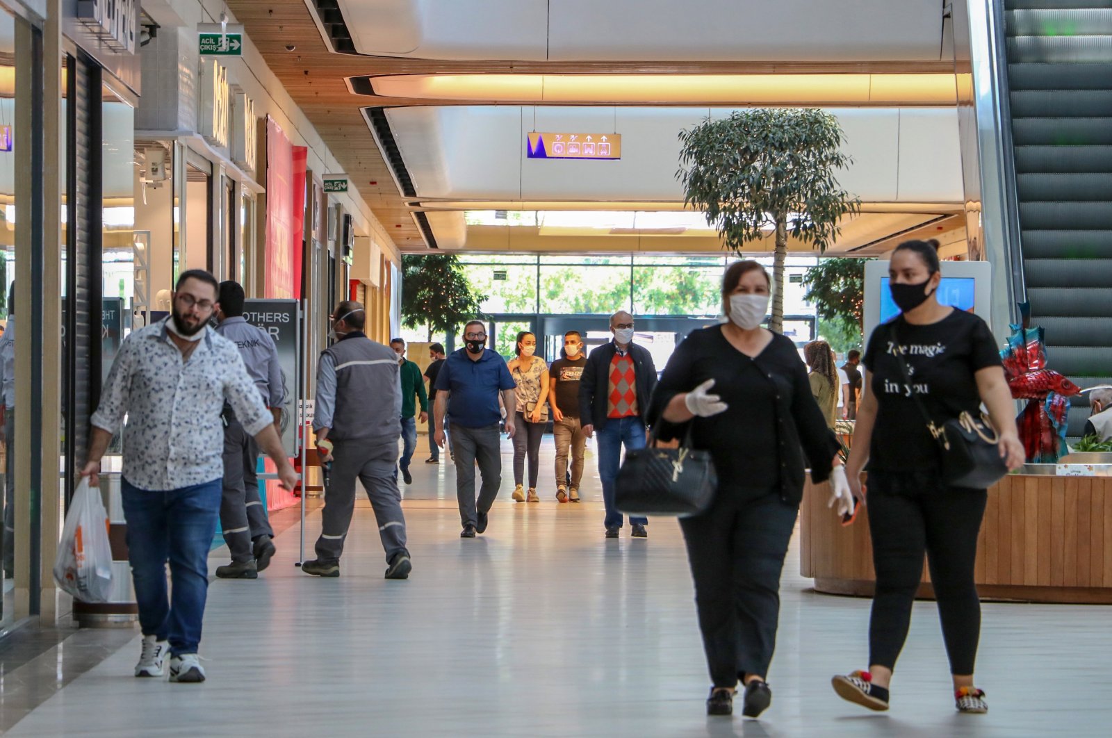 People wearing protective masks walk inside a shopping mall in Antalya, southern Turkey, May 13, 2020. (DHA Photo)