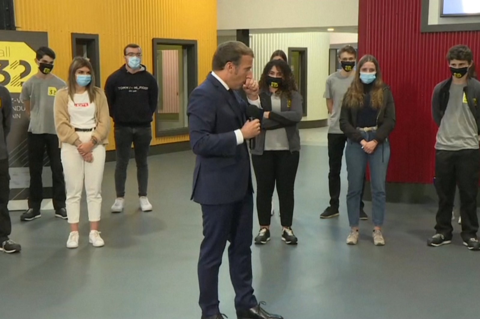 Screenshot from footage shows French President Emmanuel Macron coughing on his hand during his speech to students of a vocational school in Clermont-Ferrand, France, Sept. 8, 2020.