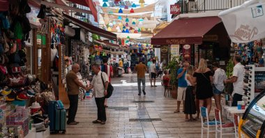 People and locals walk and shop on a shopping street near the promenade of Bodrum, August 23, 2019. (iStock Photo)